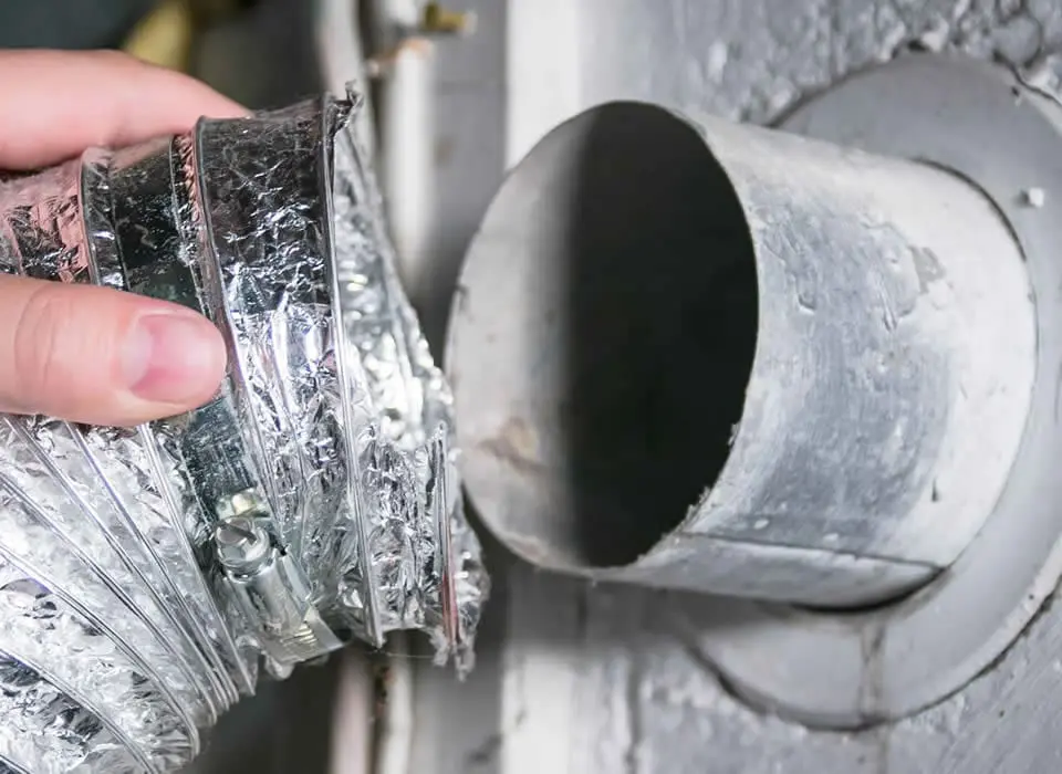 Professional dryer vent repair service featuring the installation of code-compliant metal ducting and a secure wall cap.