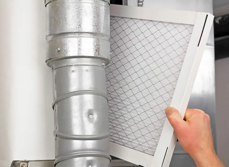 Installation of a high-efficiency furnace filter to improve indoor air quality and protect HVAC blower motors from dust buildup.
