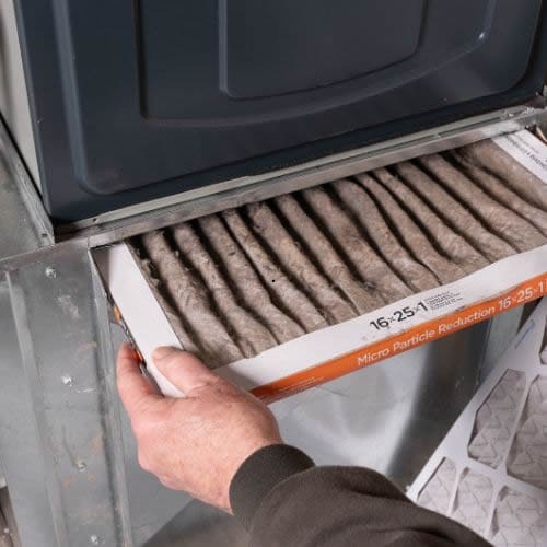 Professional furnace maintenance service: changing air filters to prevent system strain and ensure clean air circulation throughout the home
